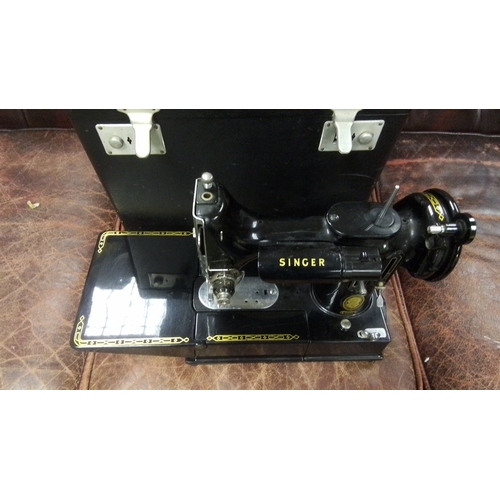 589 - A vintage Singer 222k Featherlight electric sewing machine, black enamelled with gilt decoration, in... 