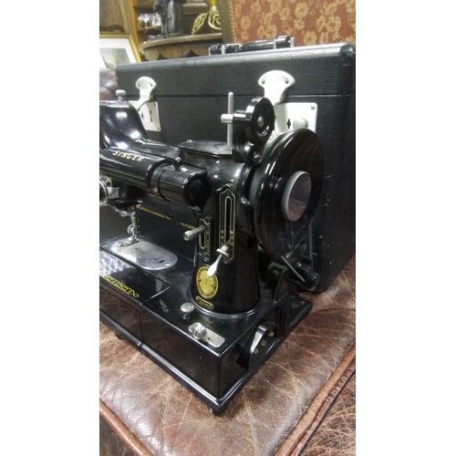 589 - A vintage Singer 222k Featherlight electric sewing machine, black enamelled with gilt decoration, in... 