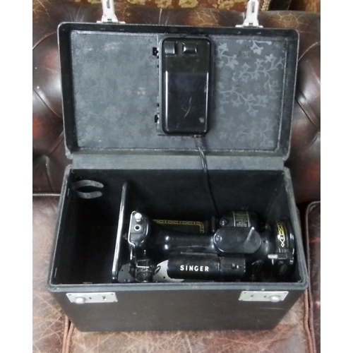 589 - A vintage Singer 222k Featherlight electric sewing machine, black enamelled with gilt decoration, in... 