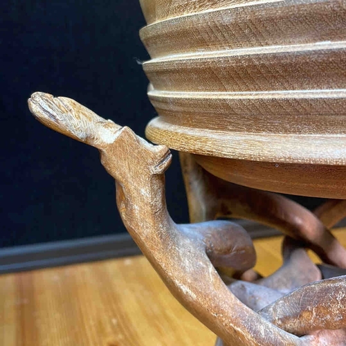 608 - A carved wooden bowl on a sculptural interlaced branch-form stand, presented with assorted seashells... 