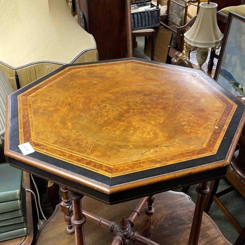 609 - An octagonal hardwood occasional table with inlaid top, ebonised apron, and turned legs united by st... 