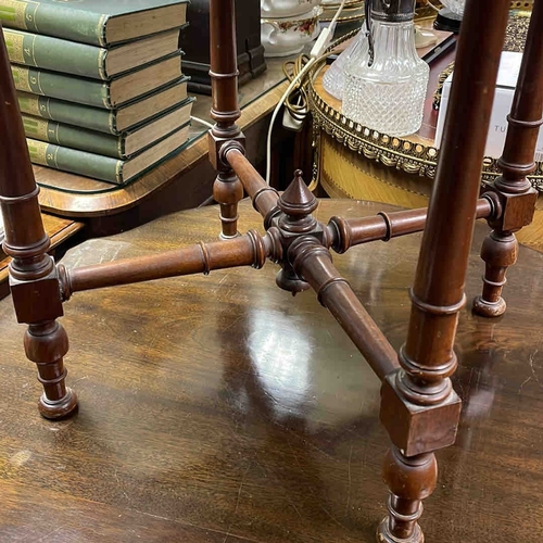 609 - An octagonal hardwood occasional table with inlaid top, ebonised apron, and turned legs united by st... 