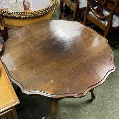 610 - A mahogany occasional table, with scalloped circular top, cabriole legs, and shaped X-form undertier... 