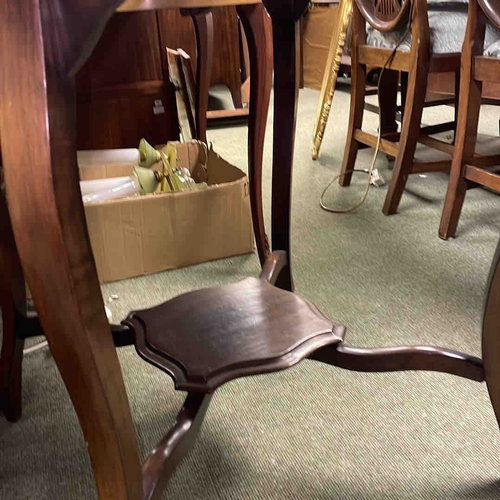610 - A mahogany occasional table, with scalloped circular top, cabriole legs, and shaped X-form undertier... 
