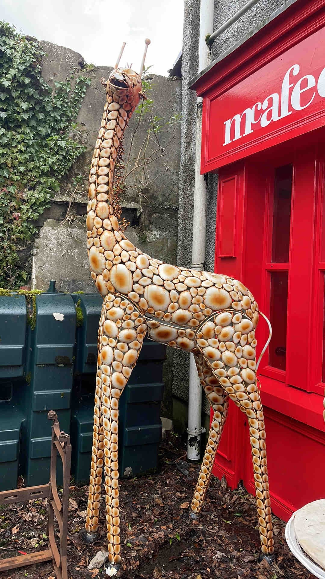 A large outdoor giraffe sculpture, formed from an openwork metal ...
