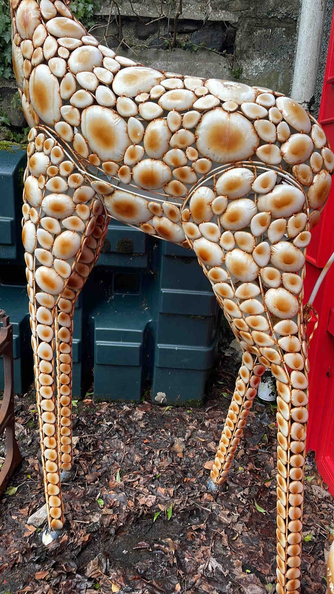 A large outdoor giraffe sculpture, formed from an openwork metal ...