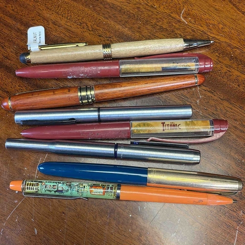 A group of vintage fountain pens and ballpoint pens, including Parker ...