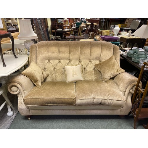 580 - A velvet button back two seater/ sofa.