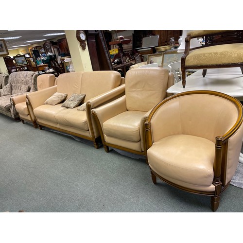583 - A cream coloured two seater sofa, two matching armchairs and a matching tub chair.