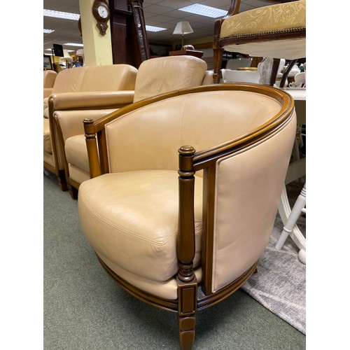 583 - A cream coloured two seater sofa, two matching armchairs and a matching tub chair.