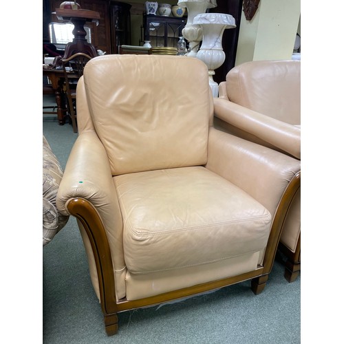 583 - A cream coloured two seater sofa, two matching armchairs and a matching tub chair.