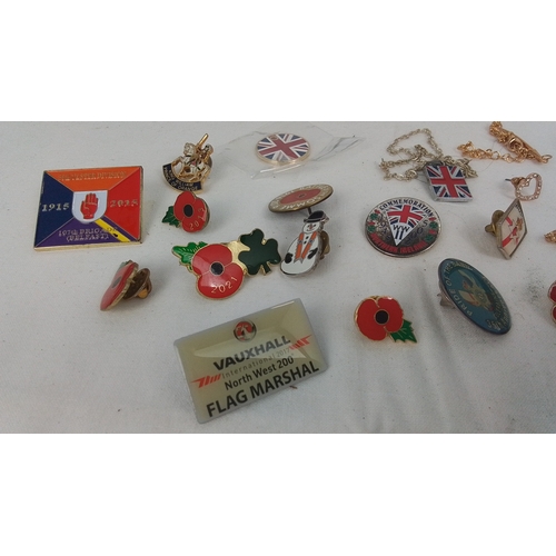 61 - A group of commemorative enamel lapel badges and pins, including Union Jack and poppy emblems, Ulste... 
