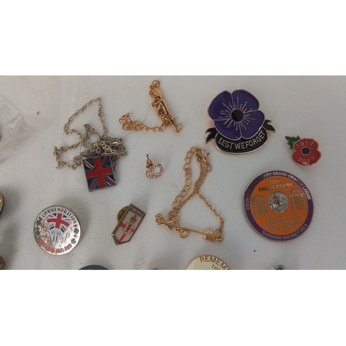 61 - A group of commemorative enamel lapel badges and pins, including Union Jack and poppy emblems, Ulste... 