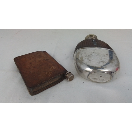 62 - A group of two liquor flasks: one in brown leather sleeve with screw-cap, the other ovoid with brown... 