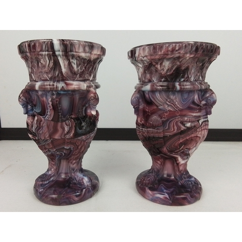 73 - A pair of marbled purple glass urn-form vases, each with a gadrooned everted rim above a moulded col... 