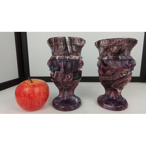 73 - A pair of marbled purple glass urn-form vases, each with a gadrooned everted rim above a moulded col... 