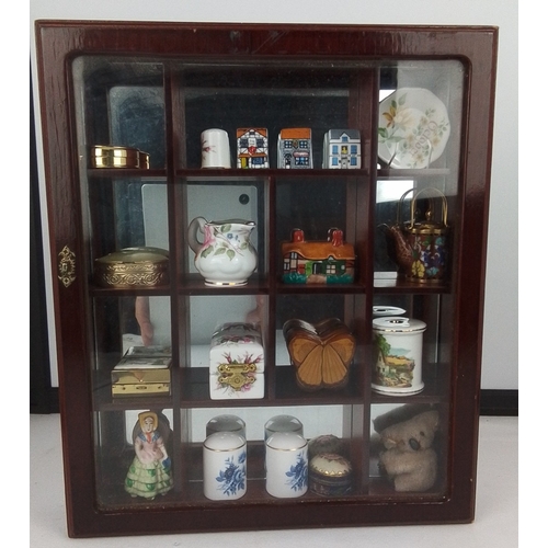 74 - A wall-mounted glazed wooden display cabinet fitted with compartmented interior, housing an assortme... 