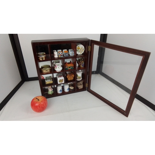 74 - A wall-mounted glazed wooden display cabinet fitted with compartmented interior, housing an assortme... 