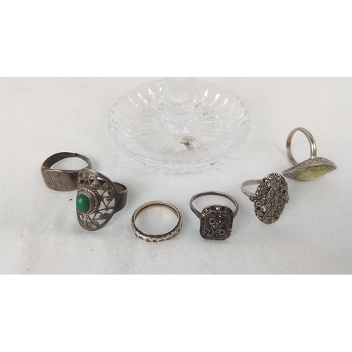 78 - A group of costume jewellery rings in silver-toned metal, including openwork settings with green cab... 