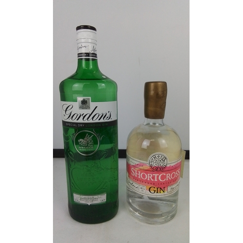 88 - Two bottles of gin comprising Gordon’s Special Dry London Gin in a green glass bottle with moulded d... 
