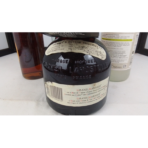 94 - A group of three bottles comprising Grand Marnier Cordon Rouge liqueur in presentation box, Gutes au... 