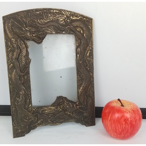 98 - Japanese-style bronze-toned metal photograph frame, cast in high relief with entwined dragons amid s... 