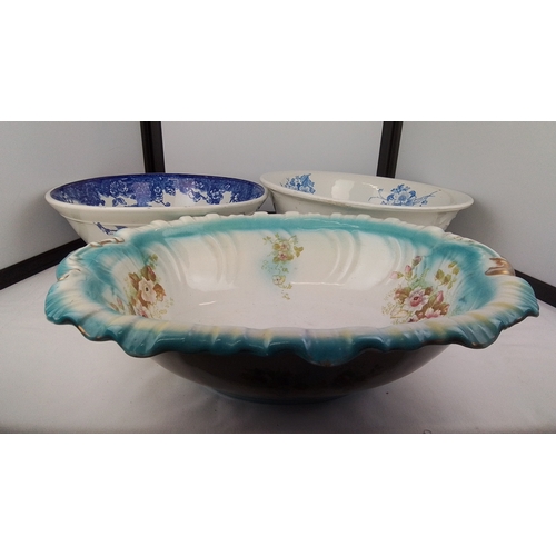 103 - A group of three transfer-printed earthenware basins, including two in blue floral patterns and an o... 