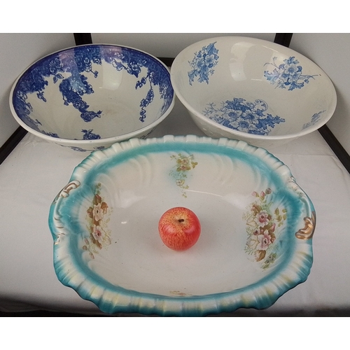 103 - A group of three transfer-printed earthenware basins, including two in blue floral patterns and an o... 
