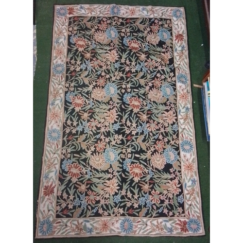 108 - Floral-pattern carpet with black field, densely scrolling polychrome flowers and foliage, within a c... 