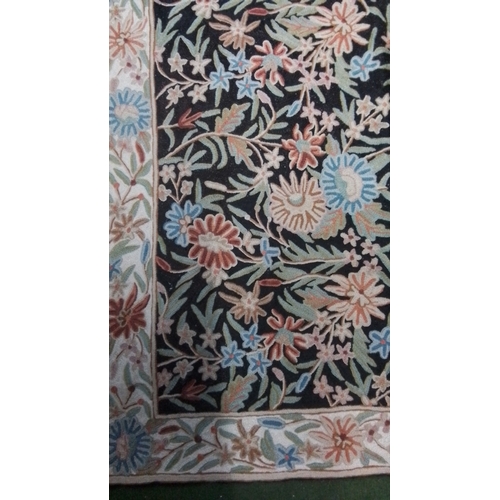 108 - Floral-pattern carpet with black field, densely scrolling polychrome flowers and foliage, within a c... 