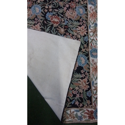 108 - Floral-pattern carpet with black field, densely scrolling polychrome flowers and foliage, within a c... 