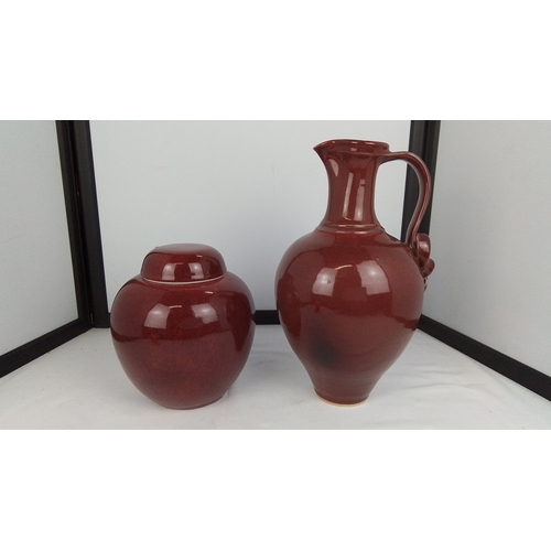 110 - A two-piece glazed stoneware grouping comprising a globular lidded jar and a bulbous ewer with high ... 
