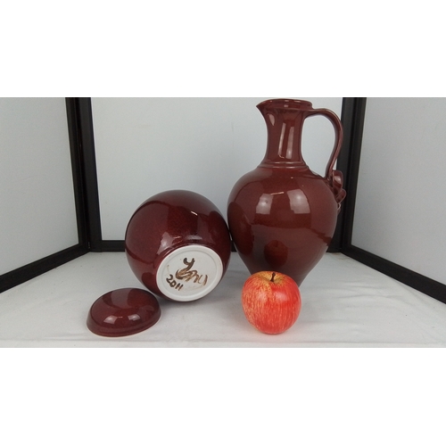 110 - A two-piece glazed stoneware grouping comprising a globular lidded jar and a bulbous ewer with high ... 