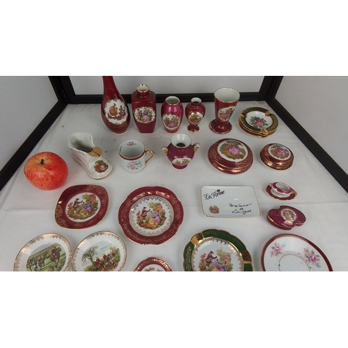117 - A group of Limoges porcelain table wares and cabinet pieces, various forms in deep claret and polych... 