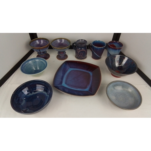 120 - A group of studio pottery table wares comprising footed bowls, a square dish, bowls and beakers, and... 