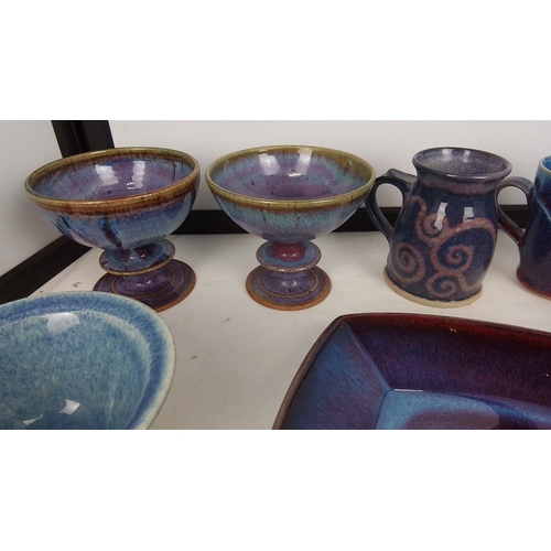 120 - A group of studio pottery table wares comprising footed bowls, a square dish, bowls and beakers, and... 