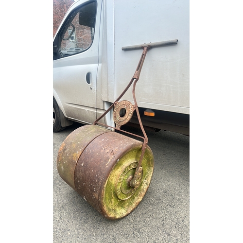 A large antique/ Early 20th century cast-iron garden roller, the drum mounted in a wrought-iron frame with tubular handlebar; the circular boss cast ‘BRITISH ROLLERS LTD’ and ‘PETERBOROUGH’, the end cap cast ‘THE ATLANTIC ROLLER’.