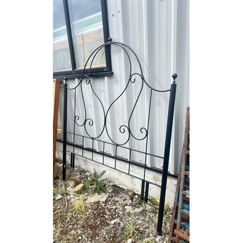 122 - An antique wrought iron headboard, 175cm x 145cm.