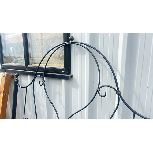 122 - An antique wrought iron headboard, 175cm x 145cm.