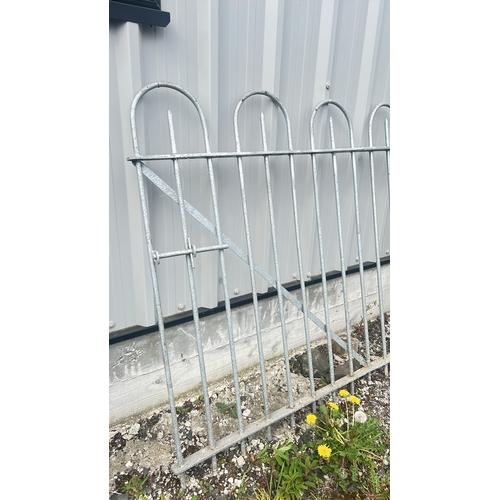 125 - A galvanised steel pedestrian gate with arched loop cresting, 125cm x 150cm.