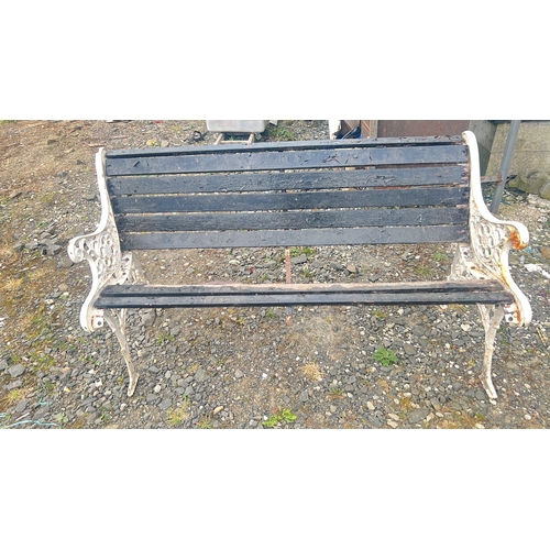 134 - Cast-iron garden bench with pierced scrolling end supports and rosette roundels, fitted with black-p... 