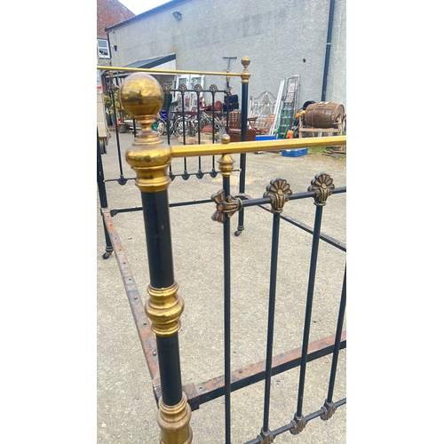 139 - Victorian brass and iron double bedstead, the black-painted end panels with finial-topped uprights a... 
