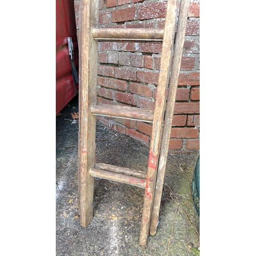 23 - A set of large extending wooden ladders.