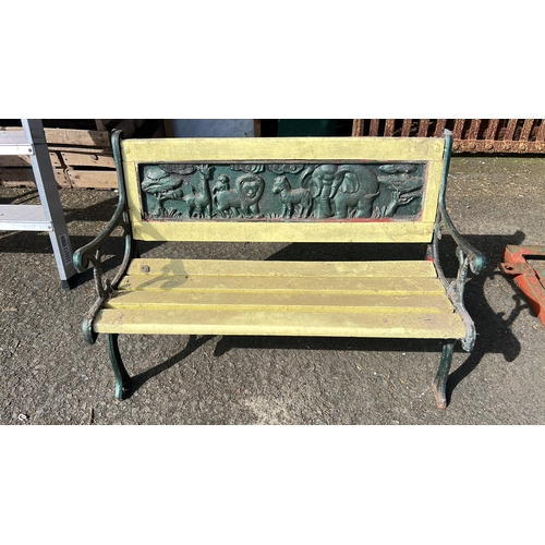 31 - Childs cast-iron garden bench with scrolled arms and slatted seat, the back rail inset with a high-r... 