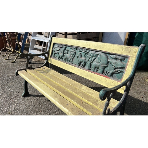 31 - Childs cast-iron garden bench with scrolled arms and slatted seat, the back rail inset with a high-r... 