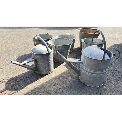 32 - Item 1: galvanised metal watering can, domed lid, top handle. Item 2: galvanised metal watering can,... 