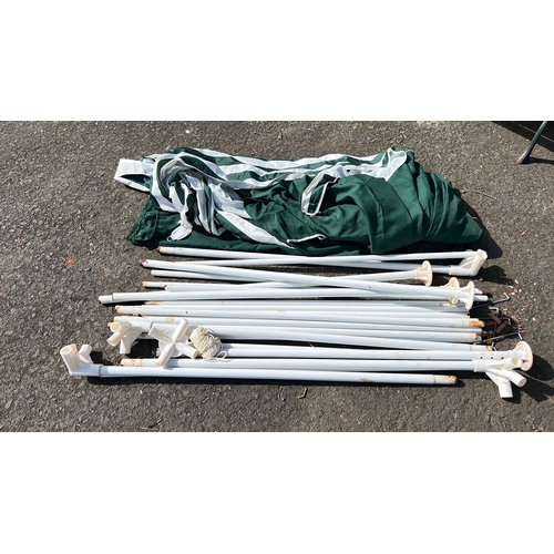 33 - A collapsible gazebo or marquee canopy in green and white striped textile, with associated white met... 