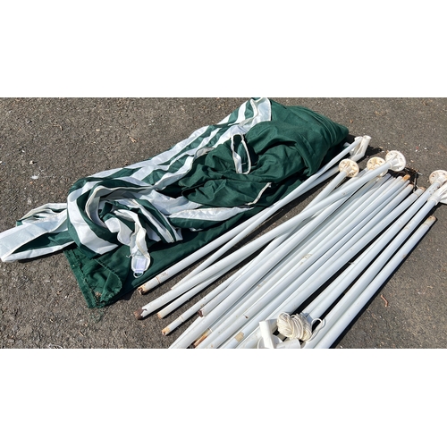 33 - A collapsible gazebo or marquee canopy in green and white striped textile, with associated white met... 