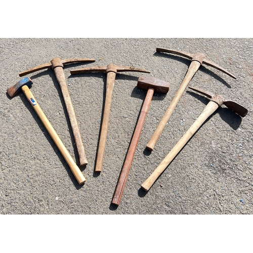36 - An assortment of tools, to include pick axe, sledge hammers & more.