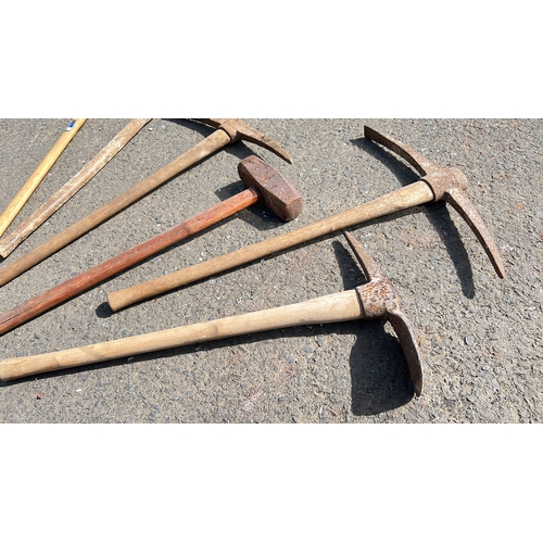 36 - An assortment of tools, to include pick axe, sledge hammers & more.